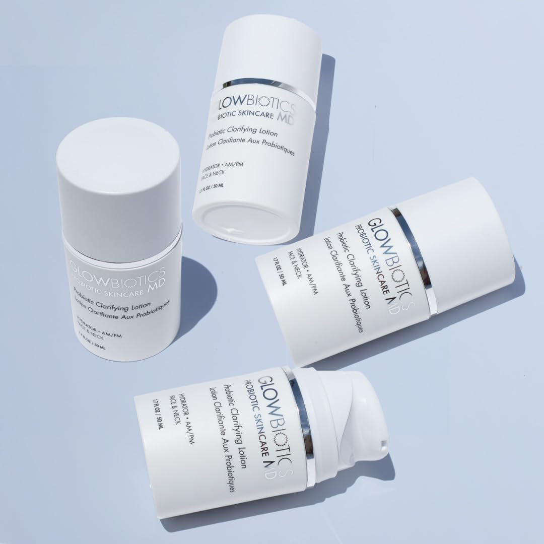 Group of Glowbiotics Probiotic Clarifying Lotion bottles arranged on a light blue background