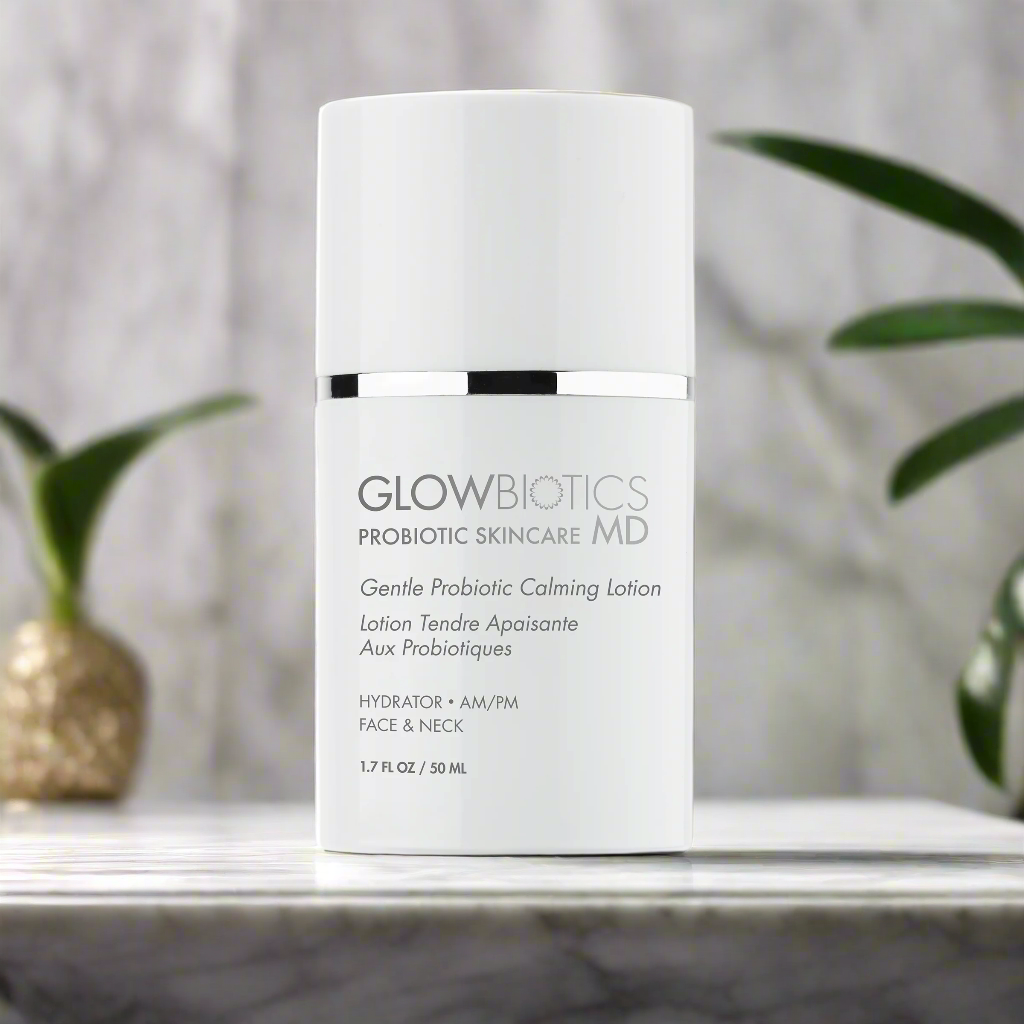 Glowbiotics Gentle Probiotic Calming Lotion bottle on surface with green plant in background