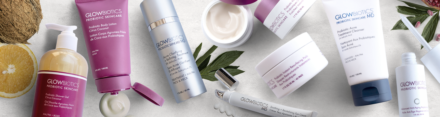 Flat-lay of assorted Glowbiotics probiotic skincare—cleanser, serum, pads and lotion—featured for combination skin needs.