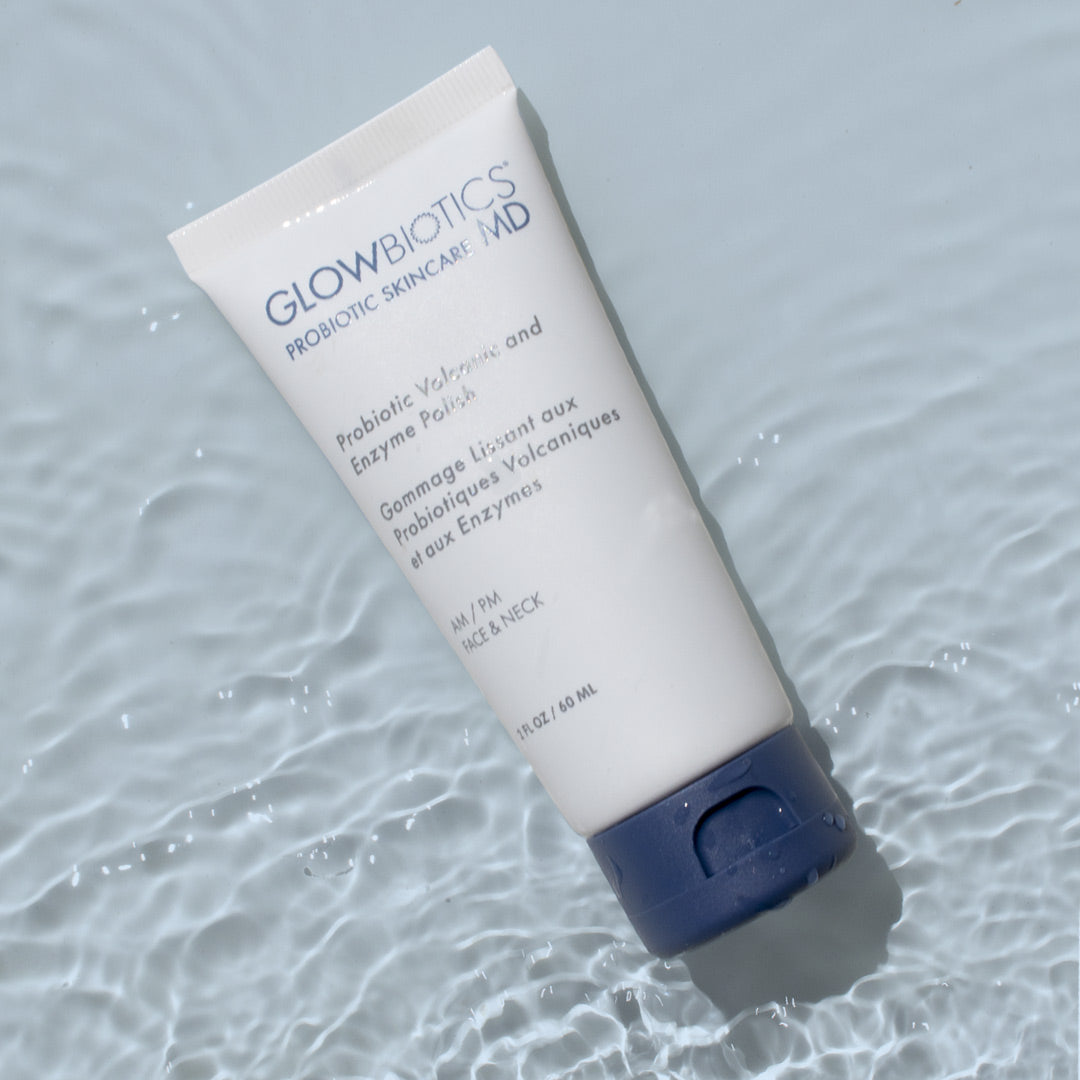 Glowbiotics Probiotic Volcanic and Enzyme Polish tube lying on a light blue rippled water surface