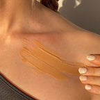 Close-up of a person’s shoulder and collarbone with two swipes of Glowbiotics Tinted Sunscreen SPF 30 Broad Spectrum UVA/UVB applied to the skin to show shade and texture