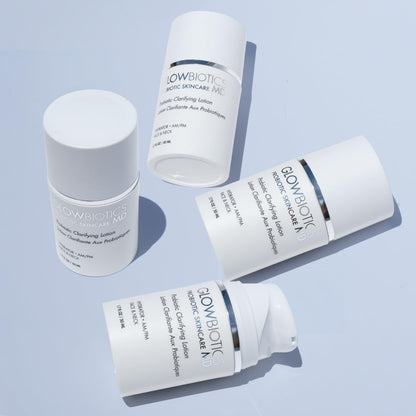 Group of Glowbiotics Probiotic Clarifying Lotion bottles arranged on a light blue background