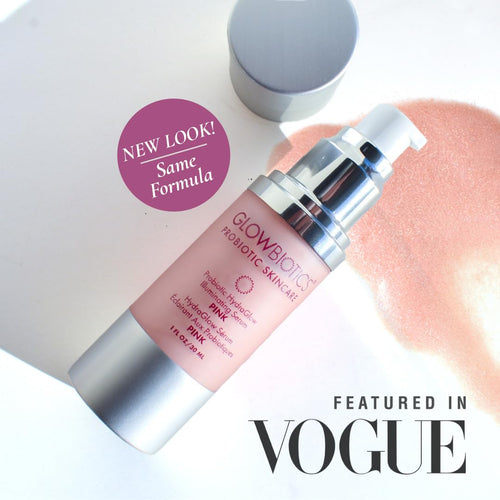 Glowbiotics Probiotic HydraGlow Illuminating Serum in pink bottle with silver pump, text overlay reads “NEW LOOK! Same Formula” and “Featured in Vogue” with pink serum background