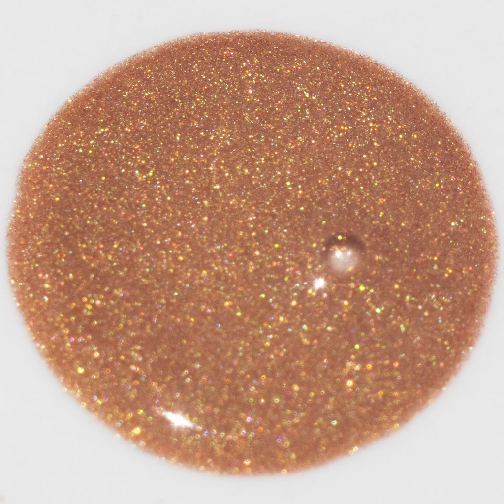 Close-up swatch of Glowbiotics Bronze HydraGlow Illuminating Serum, showing its shimmery, bronzed texture.