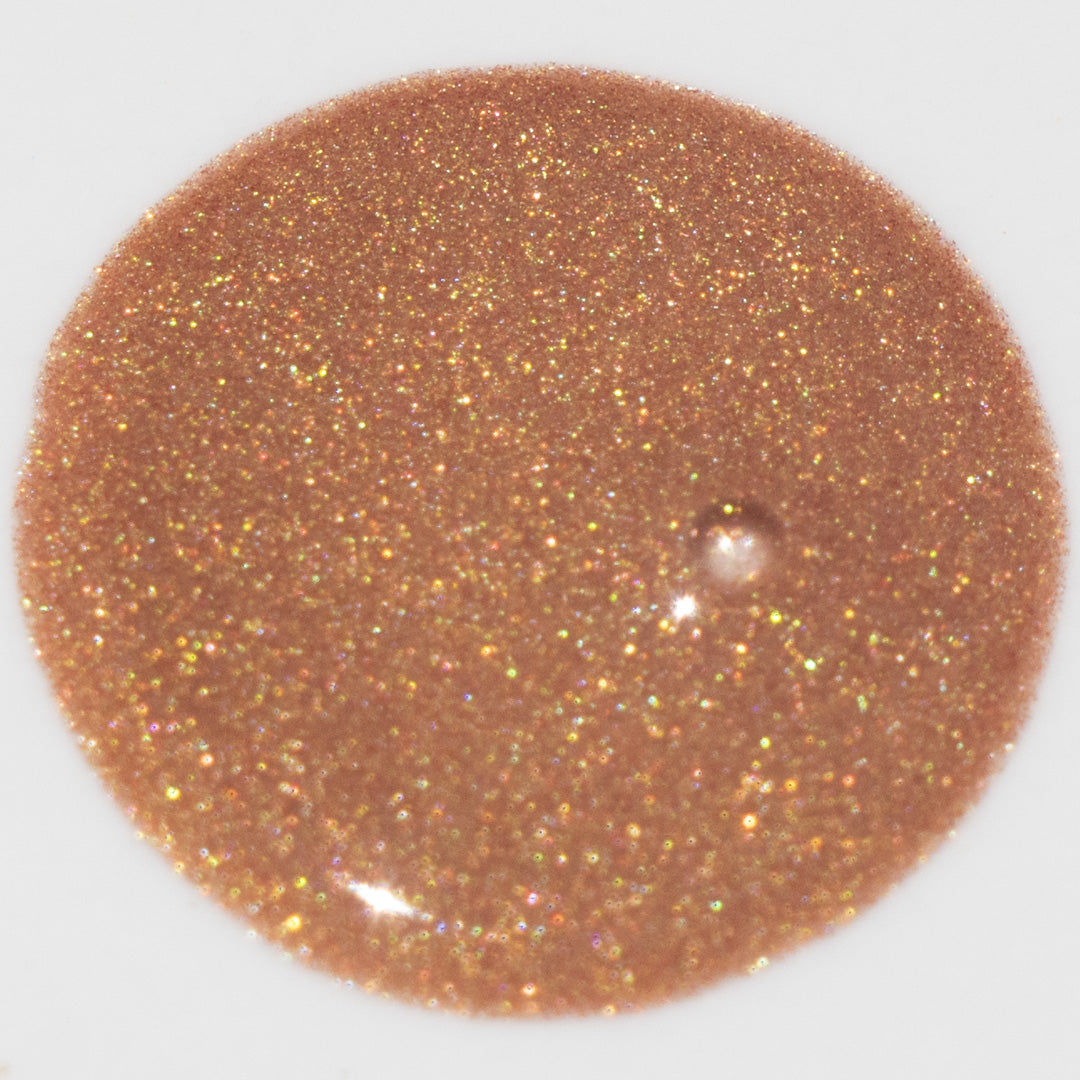 Close-up swatch of Glowbiotics Bronze HydraGlow Illuminating Serum, showing its shimmery, bronzed texture.
