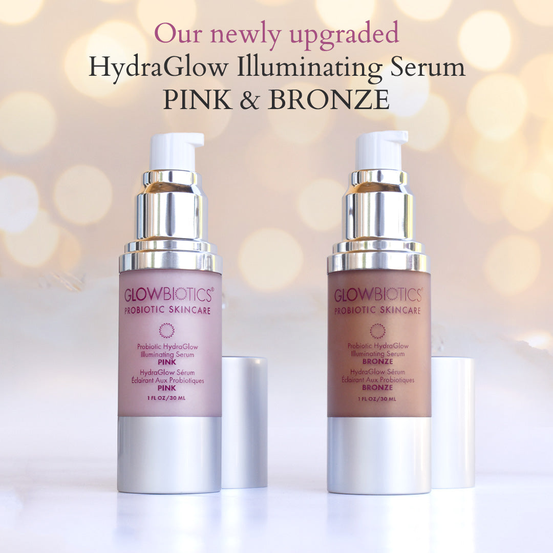 Glowbiotics HydraGlow Illuminating Serum bottles—Pink and Bronze upgraded formulas shown on soft bokeh background.
