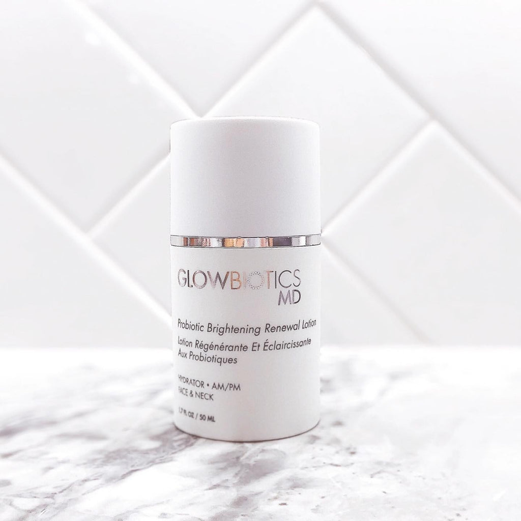 Lifestyle image of Glowbiotics Probiotic Brightening Renewal Lotion against white tile background