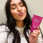 Customer smiling while holding Glowbiotics Gel to Oil Cleanser