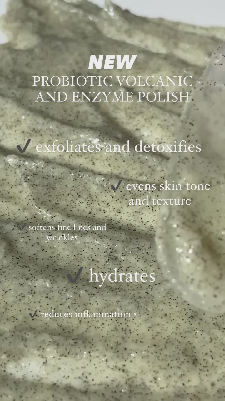Video still showing a close-up of the Probiotic Volcanic and Enzyme Polish texture spread on a surface with overlay text about the product’s hydrating benefits