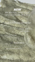 Video still showing a close-up of the Probiotic Volcanic and Enzyme Polish texture spread on a surface with overlay text about the product’s hydrating benefits