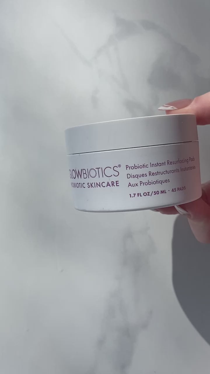 Close-up video showing Glowbiotics Probiotic Triple Action Resurfacing Pads, followed by the Probiotic Brightening + Refining Layering Solution bottle