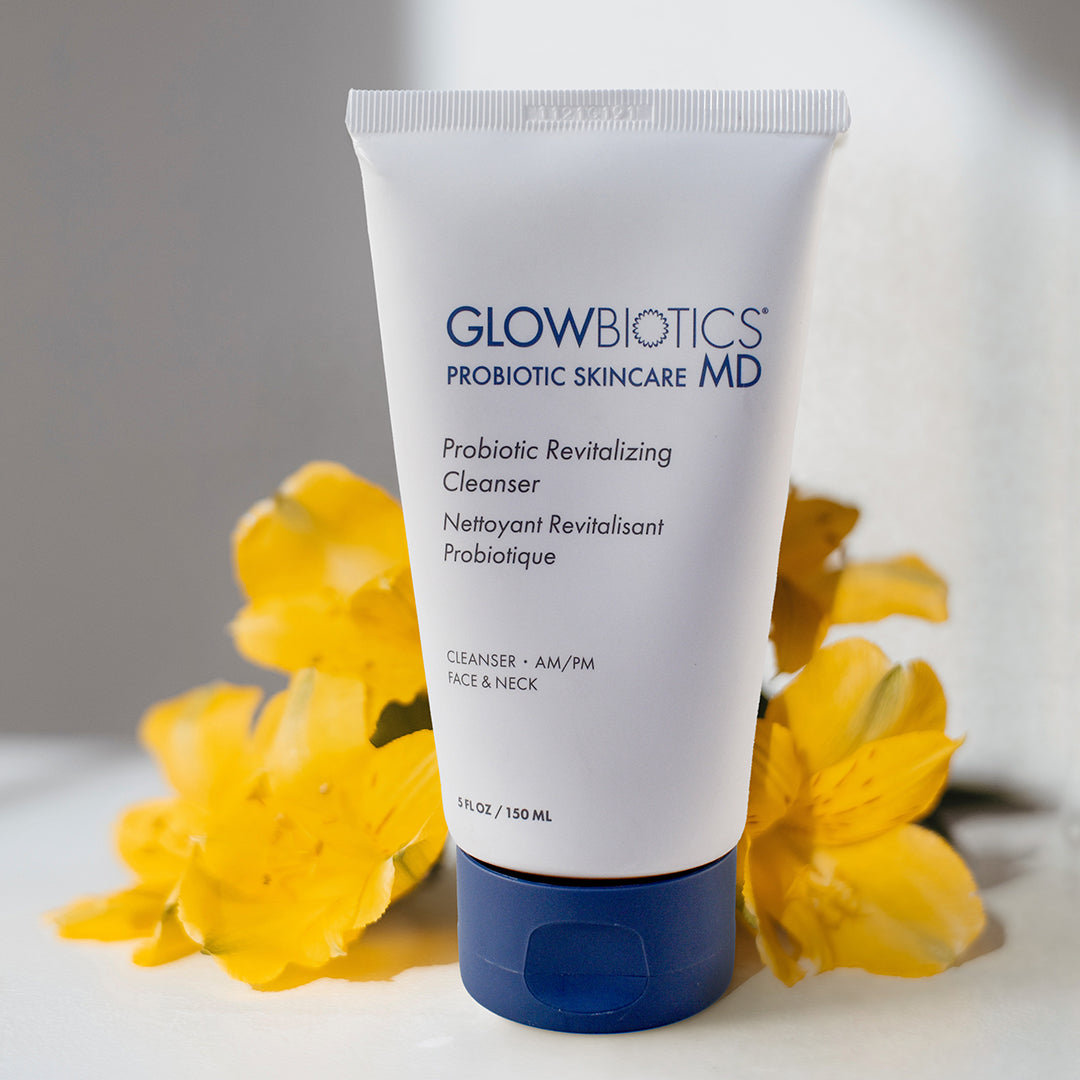 Glowbiotics Probiotic Revitalizing Cleanser surrounded by yellow flowers