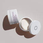 Open jar of Glowbiotics Probiotic Instant Resurfacing Pads with lid beside it, on a neutral background