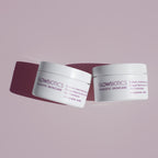 Two jars of Glowbiotics Probiotic Instant Resurfacing Pads side-by-side on a mauve background