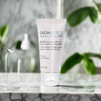 Glowbiotics Tinted Sunscreen SPF 30 Broad Spectrum UVA/UVB tube placed on a marble surface with green leaves blurred in the background for a lifestyle product shot