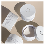 Open jar of Glowbiotics Probiotic Triple Action Clarifying Pads with lid and packaging displayed on a neutral background